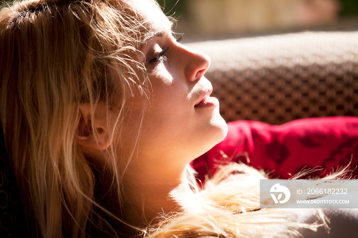 Young woman relaxing on sofa