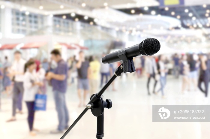 Microphone public relations on Blurred many People within Department store Shopping Mall Event hall 