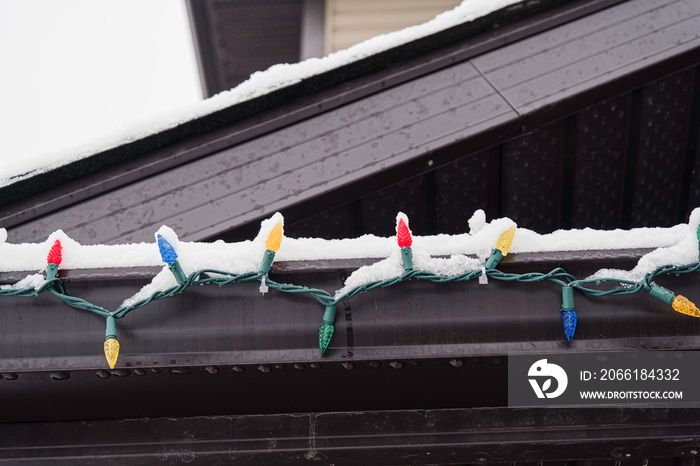 Christmas Lights hanging on roof of house