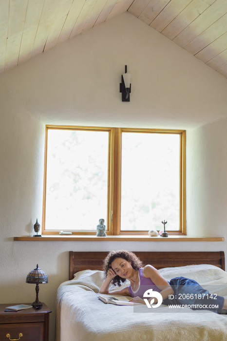 Middle aged woman reading book in the afternoon