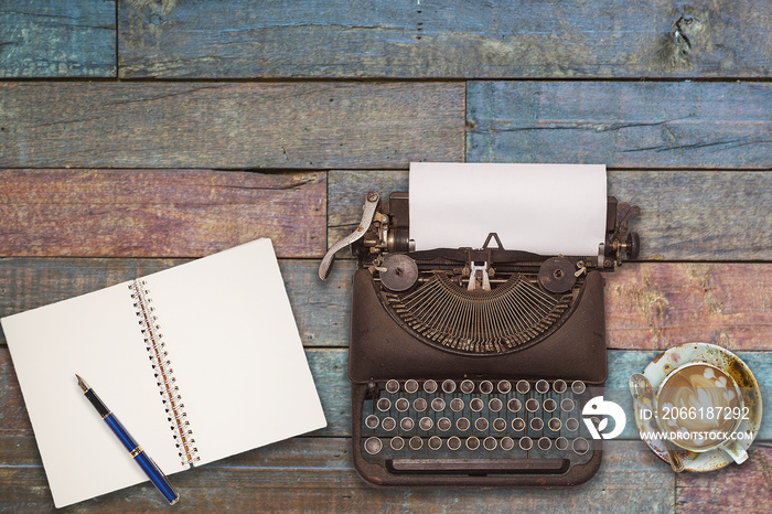 Vintage typewriter on the old wooden desk