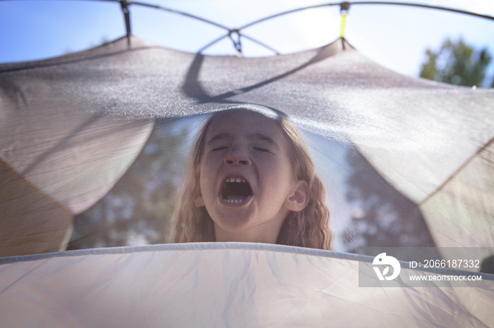 Girl (4-5) yelling in tent