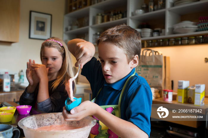 Children (6-7) making cupcakes