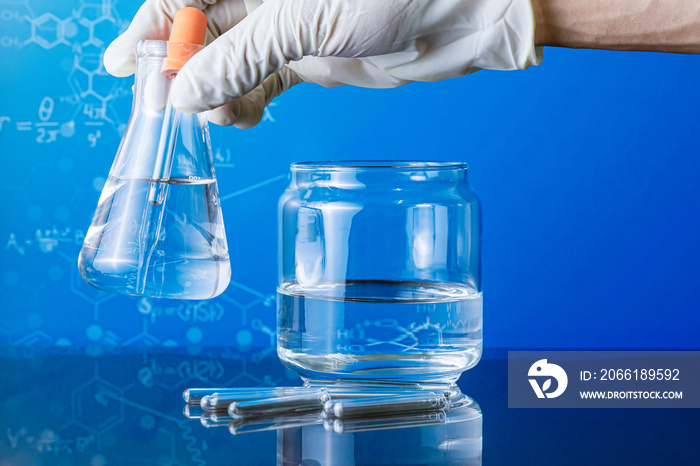 Hands of clinician holding tools during scientific experiment ,Researcher is dropping the reagent in