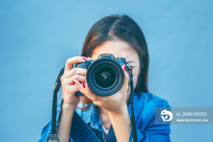 Photographer taking pictures with digital camera. Vintage tone.