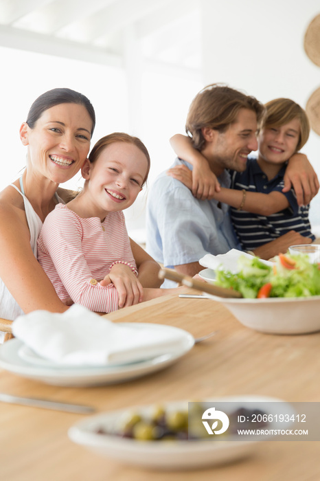 Portrait happy family eating lunch at table