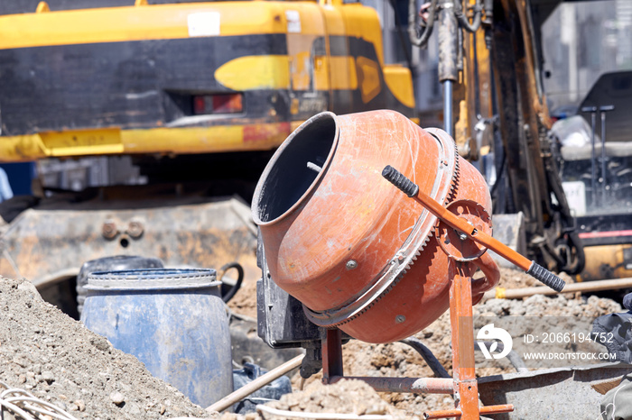 Portable cement mixer on a heavy construction site.