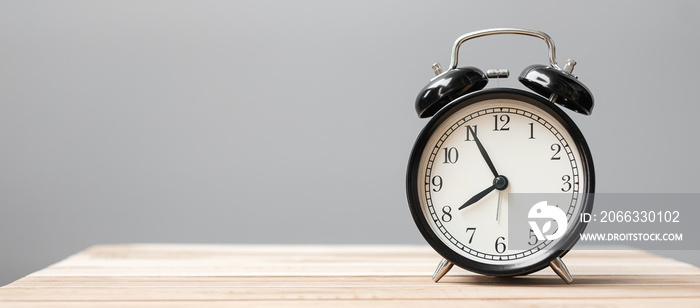 Vintage alarm clock on wooden table background and copy space for text. Activity, daily routine, morning, workout and Work life balance concept