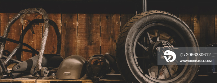 Motorcycle wheel on the floor with workshop tools, vintage garage, with blank copy space