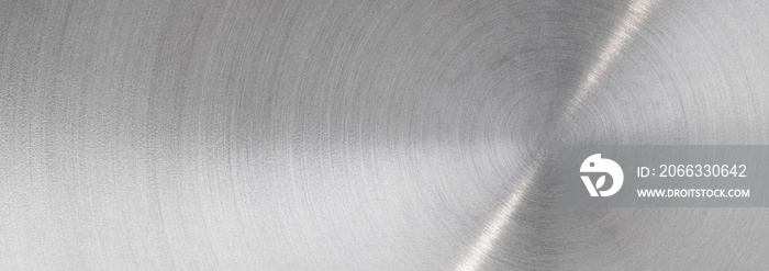 Abstract metal texture of brushed stainless steel plate with the reflection of light.