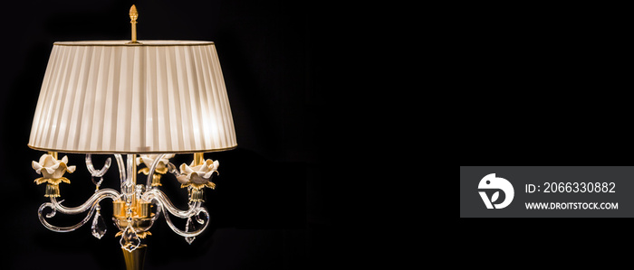 Luxury crystal glass lamp isolated on a black background.  Modern expensive table lamp