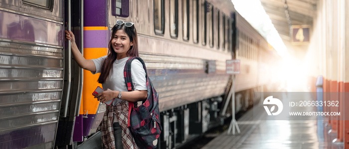 Portrait attraction asian woman boarding a train at train station for travel in summer. Travel concept