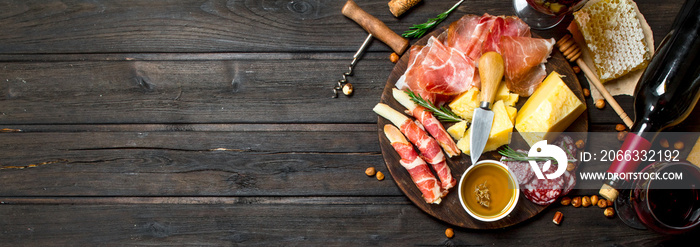 Antipasto background.Various meat and cheese snacks with red wine.