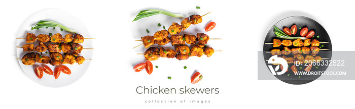 Chicken skewers with vegetables on black plate isolated on a white background. Souvlaki isolated.