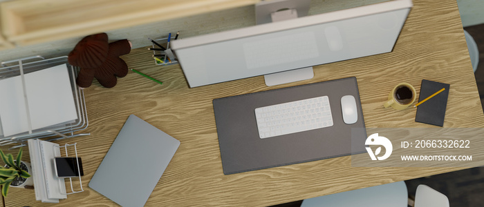 Top view of a wooden computer desk with a desktop computer mockup and office supplies