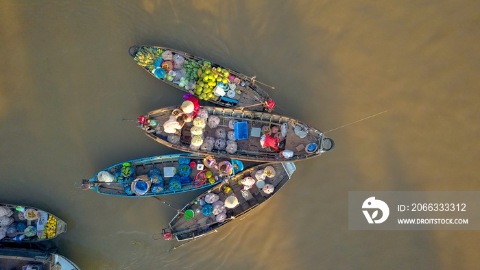 TOP DOWN: Flying away from bustling floating market on the tranquil river delta.