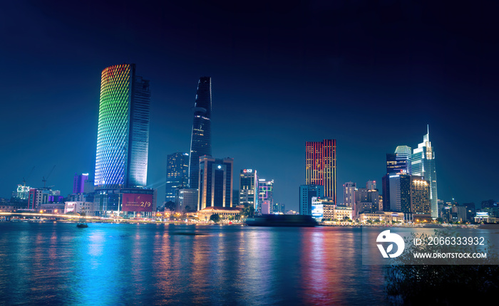 view of Bitexco and IFC One Tower, buildings, roads and Saigon river in Ho Chi Minh city - Laser and lighting show displayed. Travel and landscape concept.