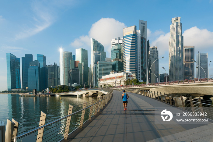 People jogging at morning in Singapore business district skyline financial downtown building with tourist sightseeing in day at Marina Bay, Singapore. Asian tourism, modern city life