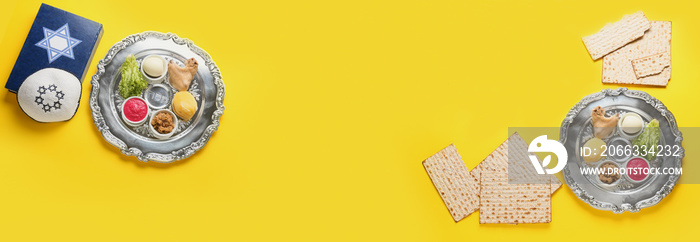 Banner with Passover Seder plates, flatbread matza and Torah on yellow background