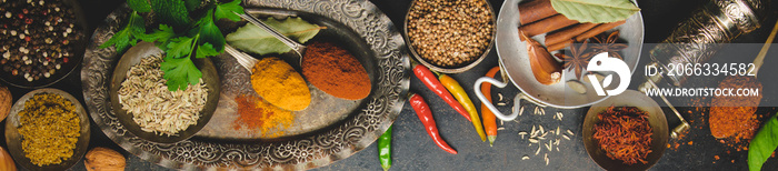 Herbs and spices on dark background, flat lay