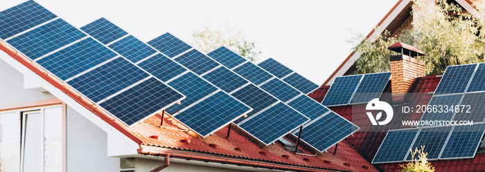 solar panels or photovoltaic power plant on roof of a house, chimney in the background