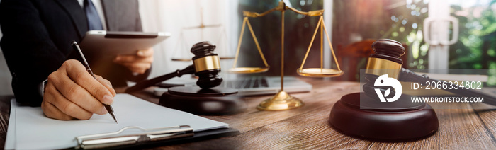 Business and lawyers discussing contract papers with brass scale on desk in office. Law, legal services, advice, justice and law concept picture with film grain effect