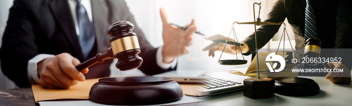 Business and lawyers discussing contract papers with brass scale on desk in office. Law, legal services, advice, justice and law concept picture with film grain effect