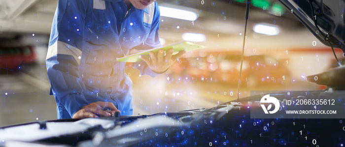 car service, repair, maintenance concept - Asian auto mechanic man or Smith writing to the clipboard at workshop warehouse, technician doing the checklist for repair machine a car in the garage,banner