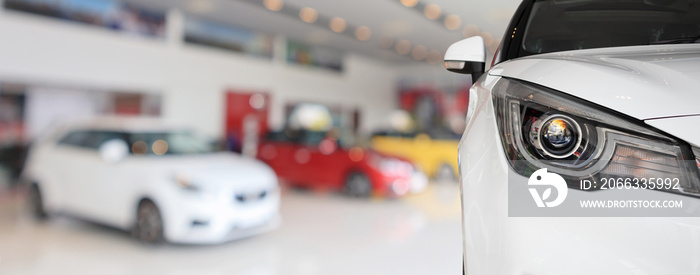 closeup front of new car in showroom background