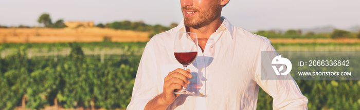 Wine tasting course outdoor at winery vineyard panoramic banner. Man holding glass of red wine at New Zealand farm tour summer vacation panorama.