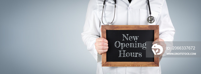 New Opening Hours. Doctor shows term on a wooden sign.