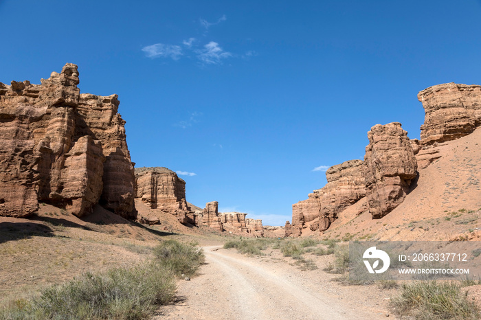 Views within the Charyn Canyon to the reddish sandstone cliffs. The canyon is also called valley of castles and is located east of Almaty in Kazakhstan.