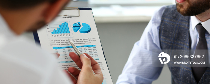 Group of businessmen with financial graph and silver pen