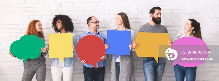 Group of millennials holding blank colorful speech bubbles