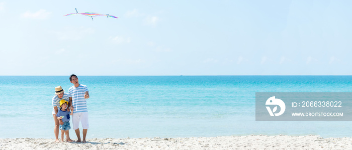 Asian happy family have fun and play kite on the beach.  Family people tourism travel in summer and holiday  for leisure and destination. Travel and Family Concept, copy space for banner