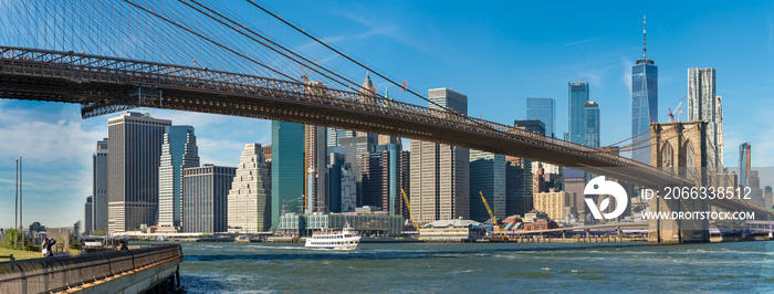 Panoramic view of Brooklyn bridge over Manhatten skyscrapers in New York.