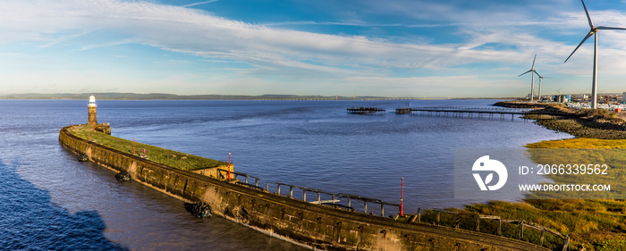 A panorama view across the breakwater of the Avonmouth Cruise port towards the Severn Bridge on a bright Autumn day