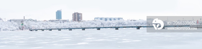 Panorama with winter lake and bridge. Environment.