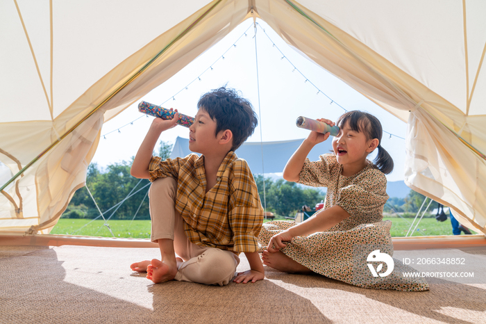 两个孩子坐在帐篷里玩耍