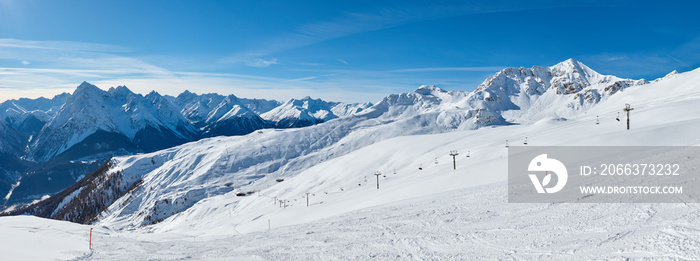 Snowy panoramic view of the ski region and mountains near Scuol resort in Switzerland.