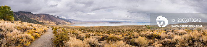 Panoramic view of the Mono Lake area; paved walking trail going towards the lake; Eastern Sierra mountains, California