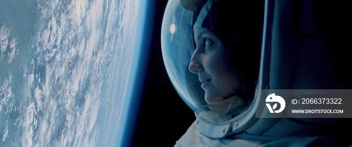 CU Portrait of Caucasian female astronaut during spacewalk on the Earth orbit. Space exploration