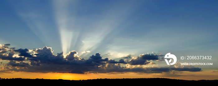 Amazing dramatic sunset, with sunbeams shining throught the clouds