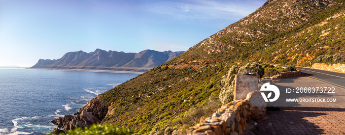 Panoramic view of the cliff of the fynbos coast in South Africa, known as the garden road and clarence drive with the Atlantic ocean in the background in the gordon bay’s area in South Africa.