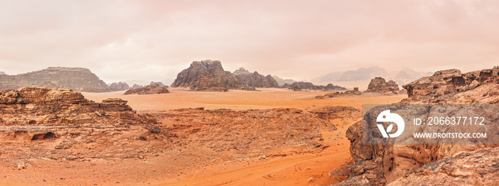 Red orange Mars like landscape in Jordan Wadi Rum desert, mountains background, overcast morning. This location was used as set for many science fiction movies