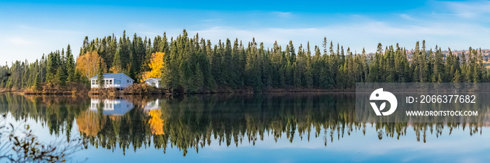 House in the forest on the lake in Canada, in autumn, beautiful colors of the trees