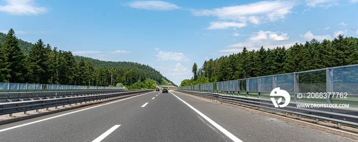 Cars are driving on the expressway or autobahn.