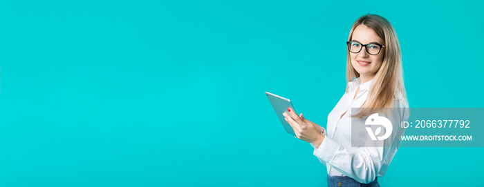 Portrait young caucasian woman worker teacher trainer mentoring in white shirt office style long hair with a tablet in hand uses technology isolated bright color blue background