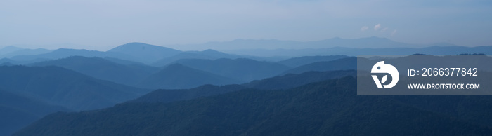 Beautiful dark blue mountain landscape of mountains. Horizontal panorama.