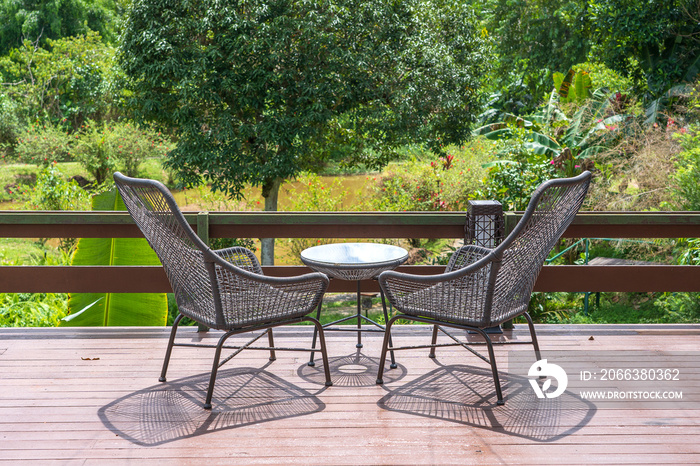 Two chairs and table on the backyard in tropical garden with beautiful view